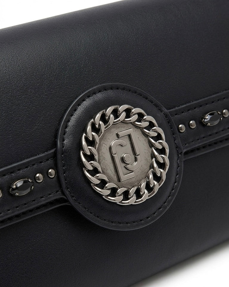 Borsa a tracolla Liu Jo nera con catena canna di fucile, logo circolare frontale e pattina decorata con pietre nere e borchie - Buttò Calzature - dettaglio.