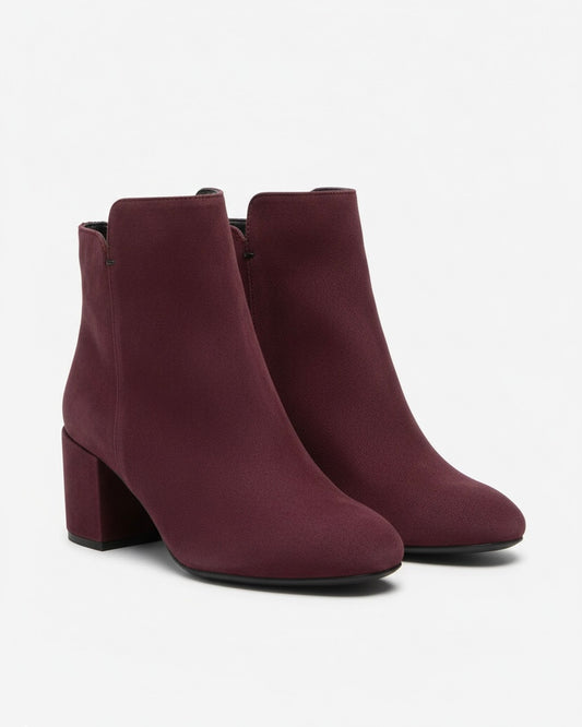 Stivaletti bordeaux scamosciati con tacco largo medio, punta arrotondata e chiusura con zip laterale.