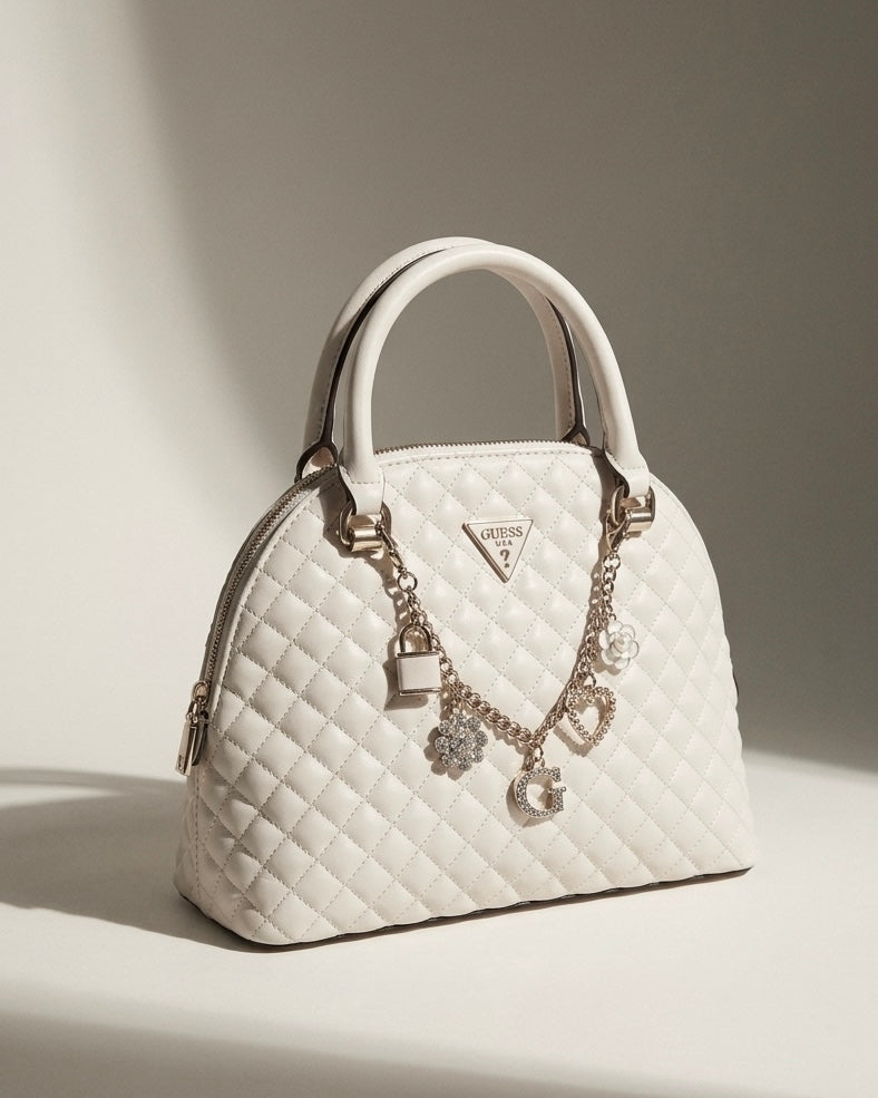 Borsa a bauletto Guess trapuntata bianca con charms gioiello dorati e logo a triangolo - Buttò Calzature.