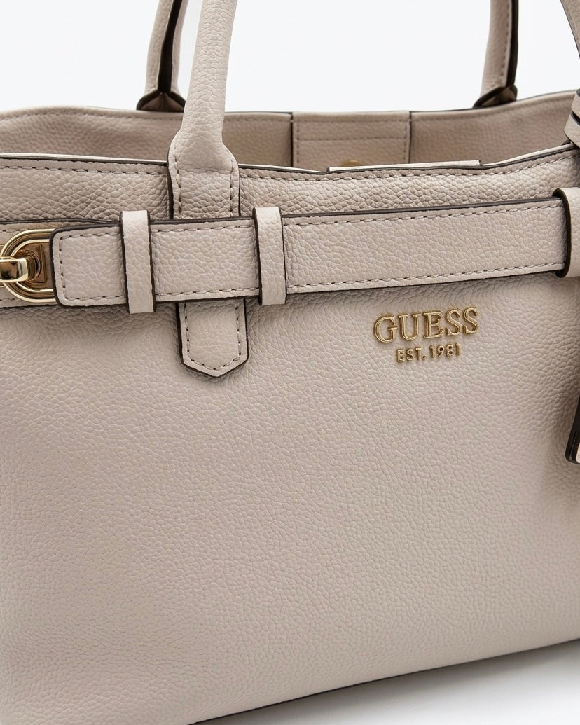 Borsa a mano Guess in ecopelle martellata color grigio tortora con charm logo e chiusura a cintura - Buttò Calzature -dettaglio logo.