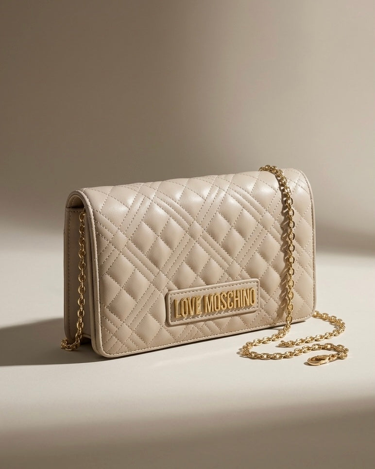 Borse Love Moschino beige nude con trapuntatura geometrica, tracolla a catena e logo dorato.