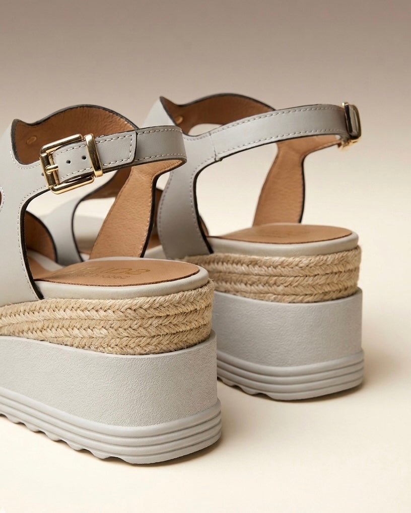Sandali donna Stonefly in pelle bianca con suola platform alta, fascia centrale sagomata decorata con borchie dorate a piramide e cinturino alla caviglia-retro.