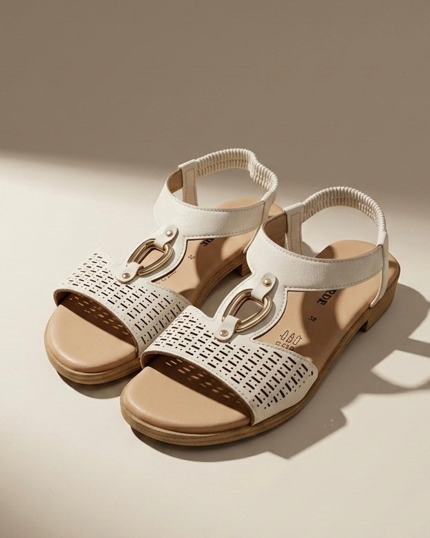 Sandali bassi Valleverde color bianco panna, fascia anteriore con lavorazione traforata geometrica opaca, dettaglio metallico dorato e cinturino elastico.