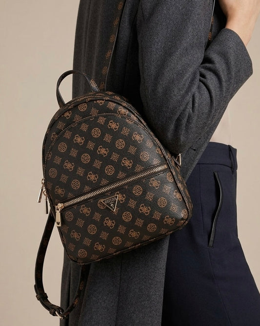 Zaino da donna brand GUESS color marrone scuro con stampa logo 4G all-over, tre tasche con zip dorate e logo a triangolo frontale-modella.